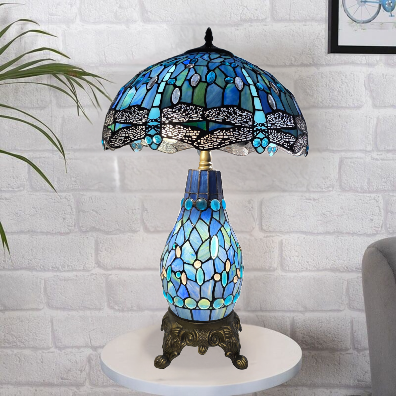 16-inch blue & black Tiffany style cluster table lamp with stained glass design on a white brick wall background