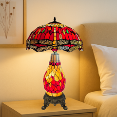 16 Inch red and yellow Stained glass cluster table lamp on a nightstand with a cozy bedroom setting