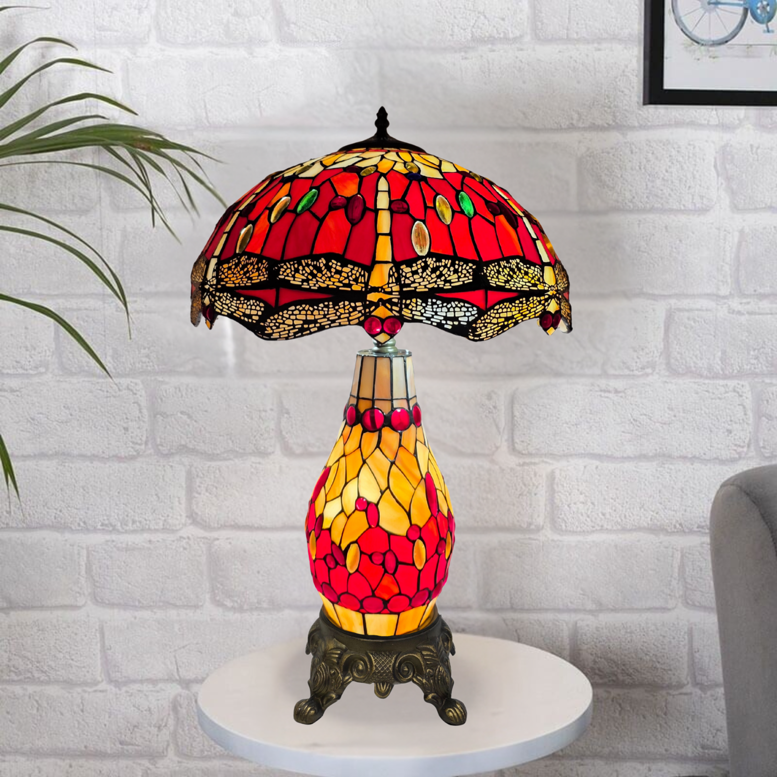 Decorative 6-inch red and yellow cluster table lamp with stained glass design on a white brick wall background