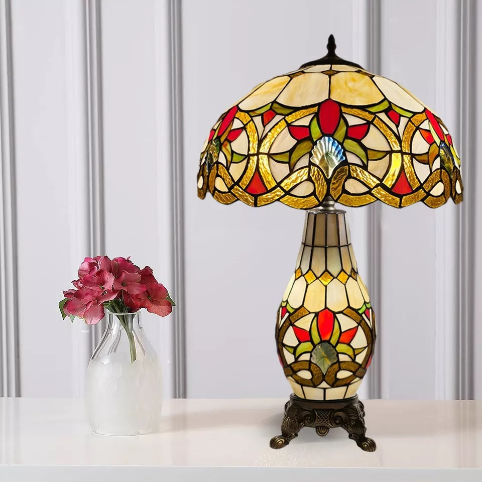 A vintage multicolor 16 inch tiffany cluster table lamp placed on a white table and with a white background