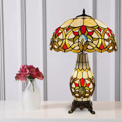 A vintage multicolor 16 inch tiffany cluster table lamp placed on a white table and with a white background