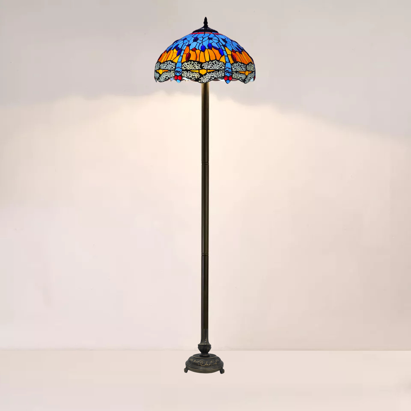 A 16 inch orange and blue stained glass tiffany floor lamp is placed on a white background 