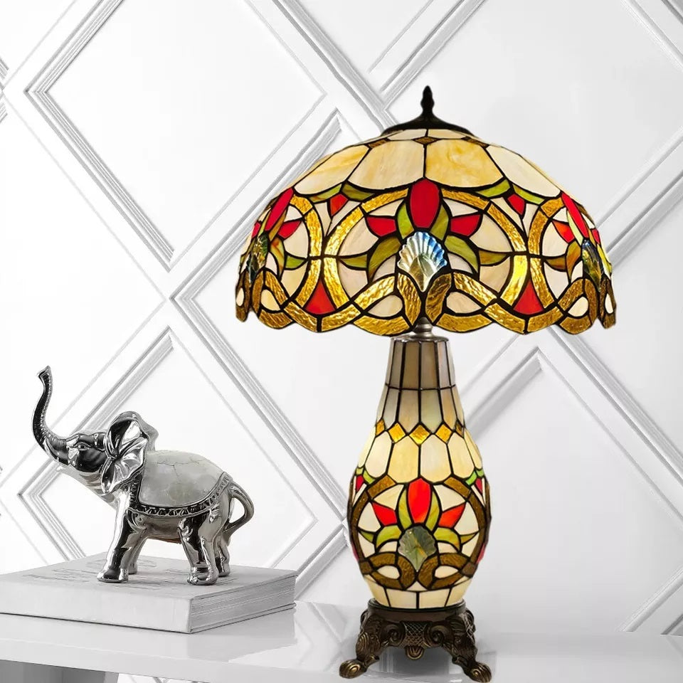 A unique vintage style multicolor stained glass tiffany cluster table lamp placed on a white background
