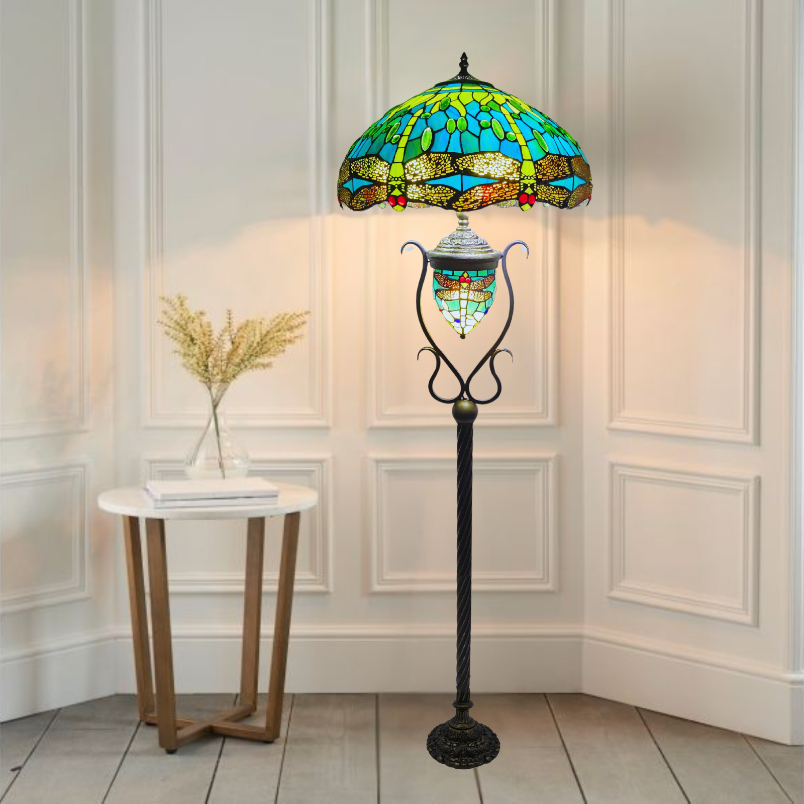 A beautiful 18 inch stained glass green color tiffany style floor lamp plced near a table with white background