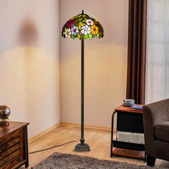 A floral design 16 inch handcrafted stained glass tiffany large floor lamp placed in a living room beside a sofa and table