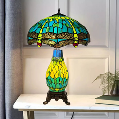 A 16 inch green stained glass cluster table lamp with a white background