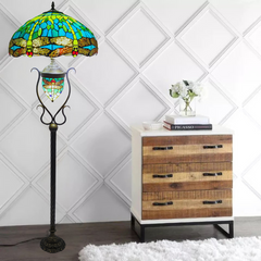 18 Inch green dragonfly stained glass tiffany style floor lamp with a white bachkground placed in a living room