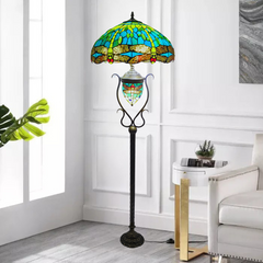 Green handcrafted dragonfly tiffany style 18 inch floor lamp with a white background 