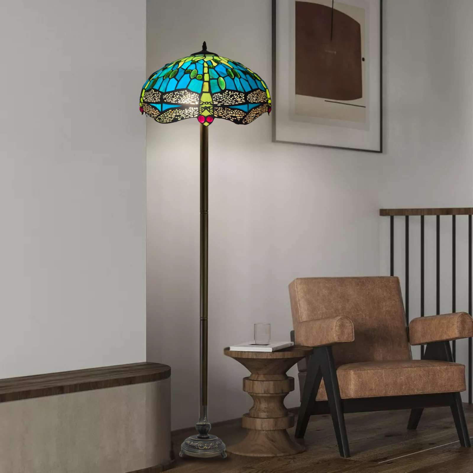A beautiful green stained dragonfly 16 inch large tiffany floor lamp is placed in a living room baside a chair and a table