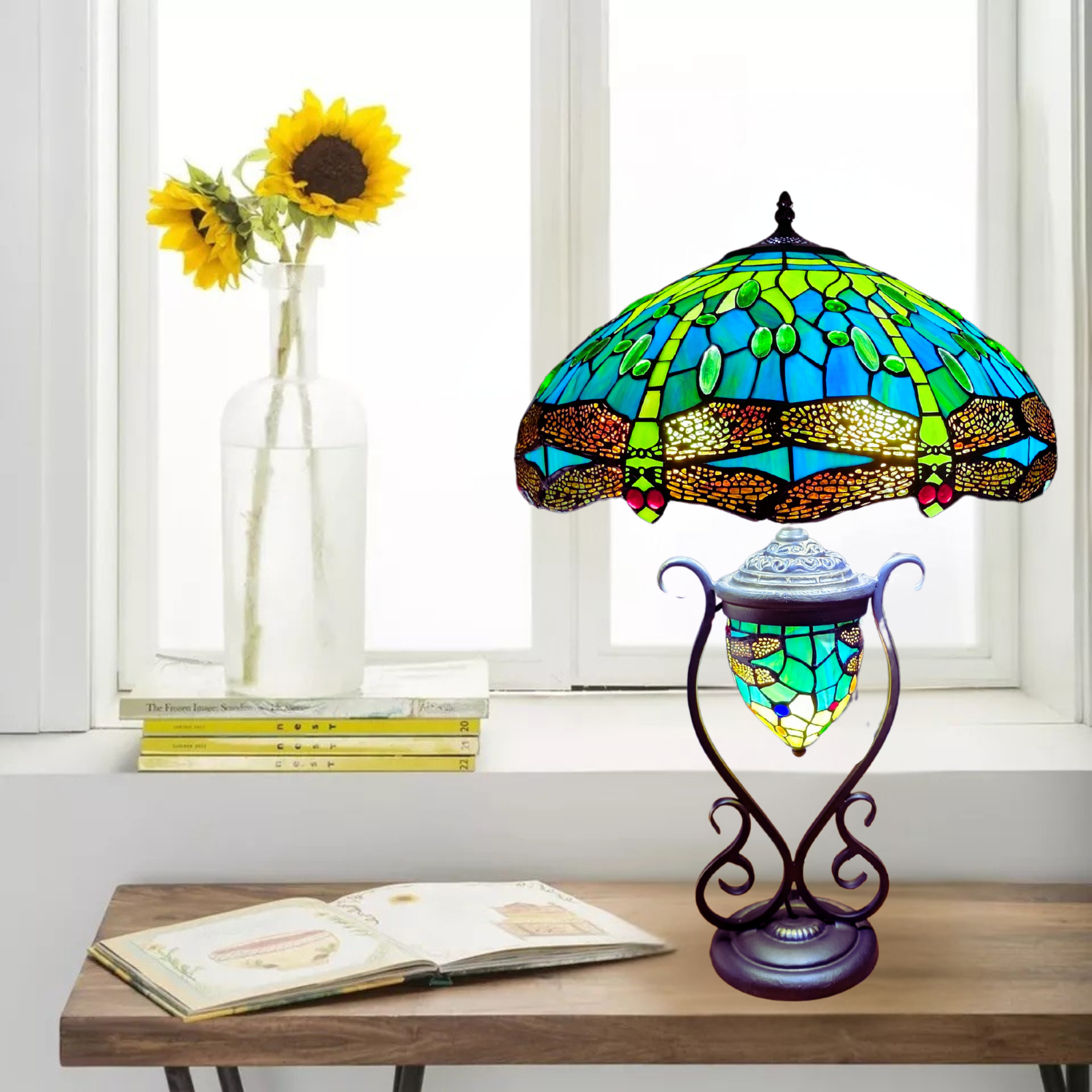 A tiffany style green stained glass dragonfly 18 inch cluster table lamp placed on a desk 