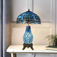 Blue & black 16-inch tiffany style stained glass cluster table lamp on a white surface with a neutral background